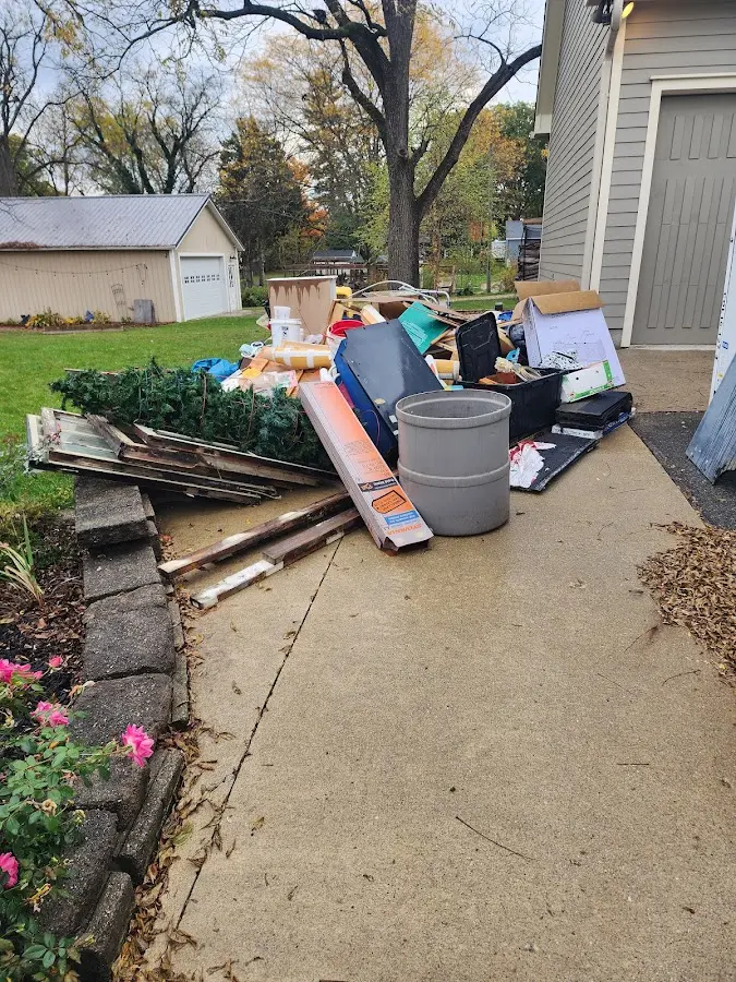 Dumpster being loaded with debris for Estate Cleanout Dumpster Rental in West Rockhill